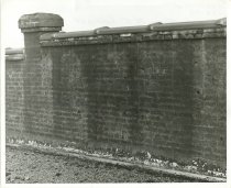 Black and white photograph depicting fire damage of parapet near northeast