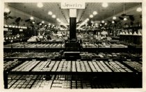 Black and white photographic print depicting interior jewelry sales area, p