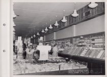 Black and white photograph of sales floor and shoppers