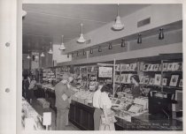 Black and white photograph of sales floor and shoppers