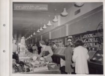 Black and white photograph of sales floor and shoppers