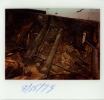 Color polaroid depicting  interior floor damage, taken in August 1979 (phot