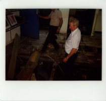 Color polaroid depicting  interior floor damage, taken in August 1979 (phot
