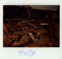 Color polaroid depicting  interior floor damage, taken in August 1979 (phot