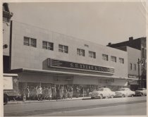 Black and white photograph of Kress store front with customers lined up