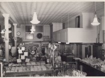 Black and white photograph showing the interior of the Kress store. Clothin