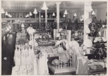 Black and white photograph showing the interior of the Kress store. Clothin