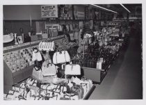 Black and white photograph of Kress sales floor showing handbags and advert