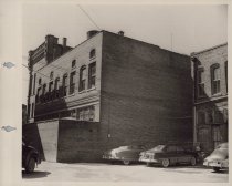 Black and white photograph of Kress store back alley with the parking lot v