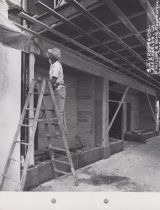 Black and white photograph of Kress display windows being installed.