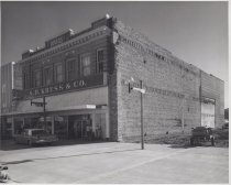 Black and white photograph of Kress store front with side lot under constru