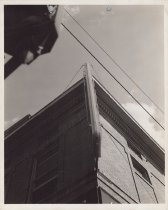 Black and white photograph of Kress store featuring the hanging sign