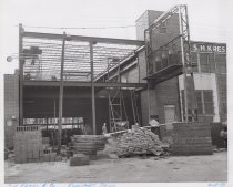 Black and white photograph of Kress construction site with the frame being