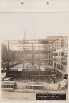 Black and white photograph of Kress construction site with frame being cons
