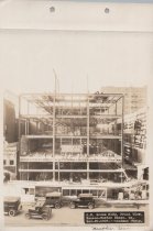 Black and white photograph of Kress construction site with frame being cons