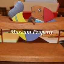 Wooden rolling mechanical toy.