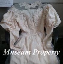 Cream colored wedding gown.