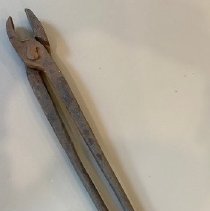 Tongs used in metalworking with a forge.