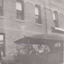 Postcard of girl sitting in c1917 Ford.