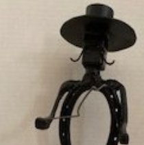 Water witcher sculpture made from horseshoes.