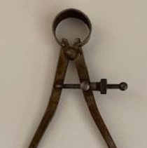 Outside caliper used in woodworking for accurate measurements.