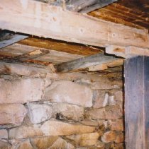 Back inside wall against hillside of May Wing barn.