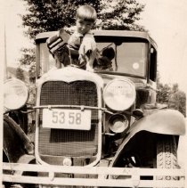 Douglas Marks pouring water into a Studebaker.