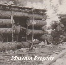 John Hedquist in log cabin in Comet.
