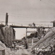 Two men pushing ore car at Comet Mine.