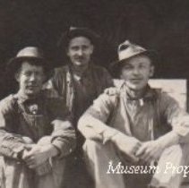 Men sitting in ore bin at Comet Mine.