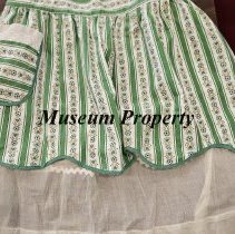 Light green apron with dark green stripes and flowers