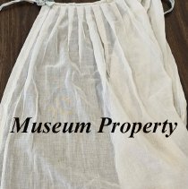 White apron with off green ribbon