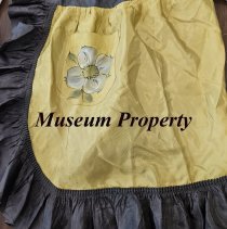 Green satin apron with black trim and painted flower