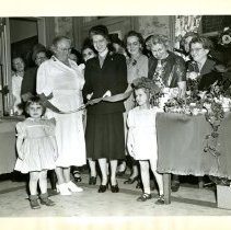 Mrs. John Grace Cutting a Ribbon