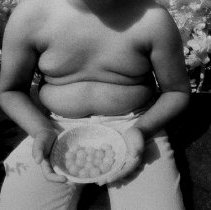 Irwin holding a plate of cherry tomatoes