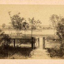 South Beach Street yard with open fence door leading out to river front.