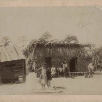 African-American family outside cottages
