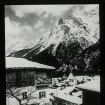 Image of two houses covered in snow. Huge mountain covered in snow backgrou