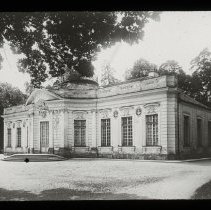 Image of a building with many windows surrounded by trees.