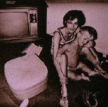 The People of America (little man sitting between woman's legs)