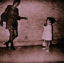 The People of America (big and little women talking in hallway)