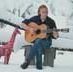 Portrait of Stephen Stills playing guitar in the snow, Gold Hill, Colorado