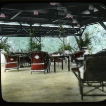 woman seated in wicker chair