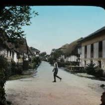 Boy crossing rural street