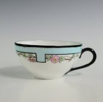 Hand-Decorated Cup and Saucer Featuring a Stylized Border and Roses