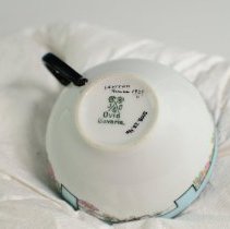 Hand-Decorated Cup and Saucer Featuring a Stylized Border and Roses