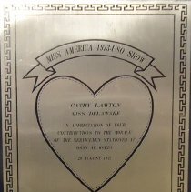 plaque/presented to cathy lawton by the 1973 uso show
