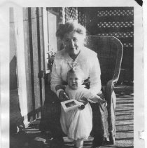 Amalia Paul with child on porch of Coolin home