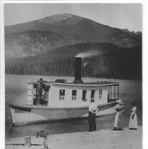 W.W. Slee near beach with three people on shore