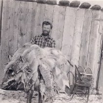 Man with a pile of furs